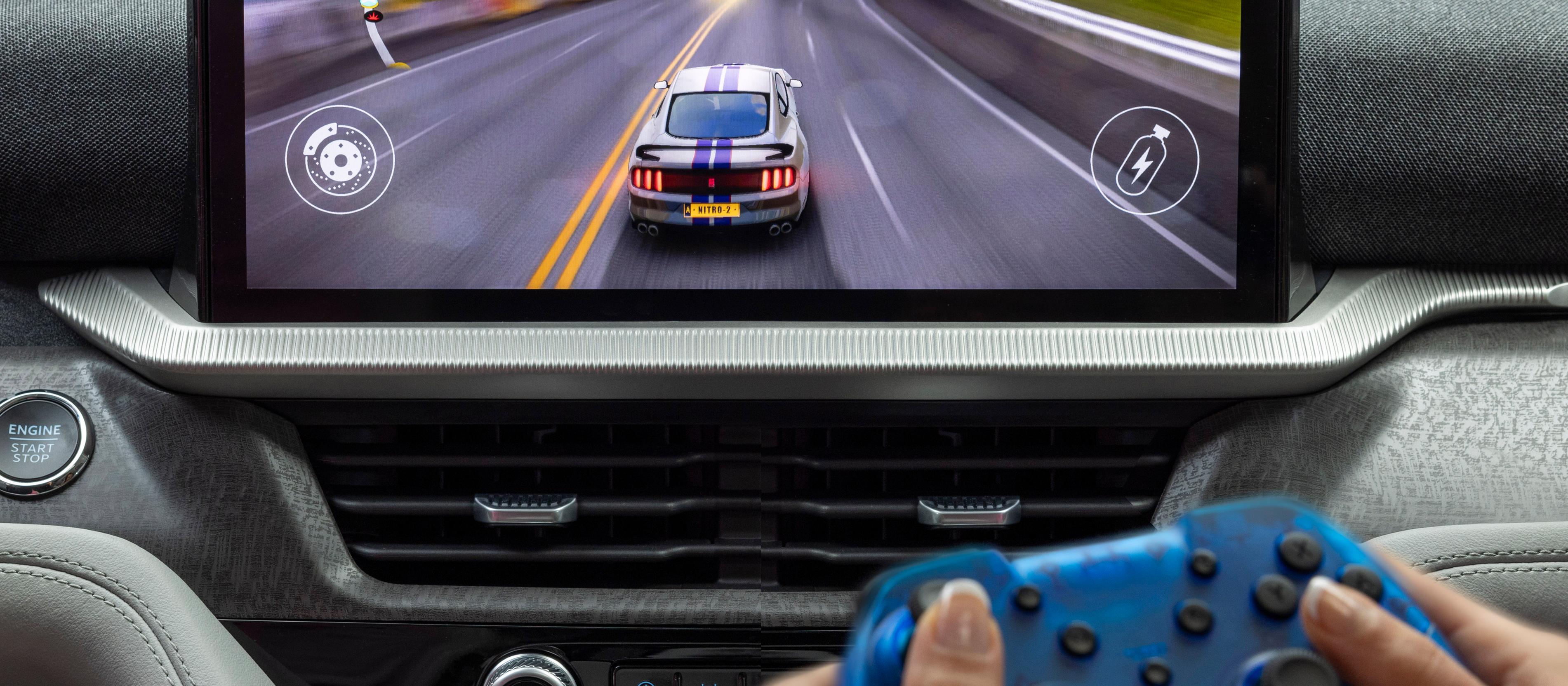 A passenger playing a racing game on the center display of a parked 2026 Ford Explorer® SUV