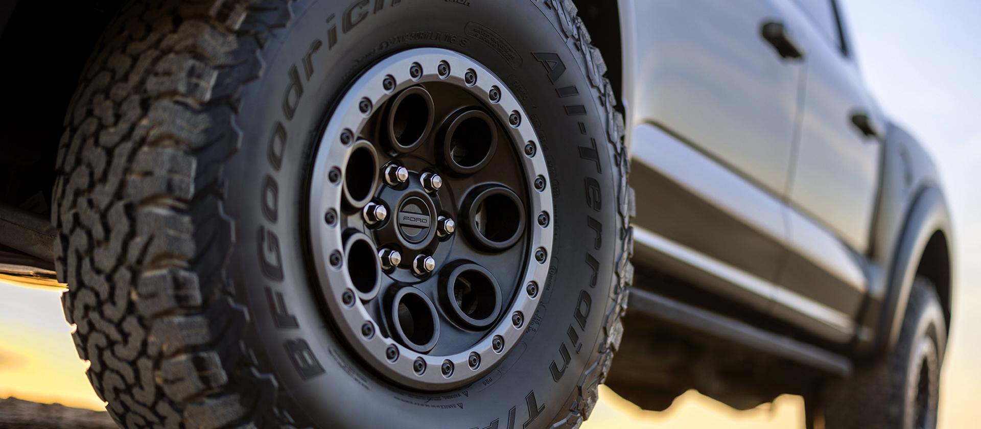 Close up view of a rugged, all-terrain tire, it's aggressive treading indicating its impressive gripping power