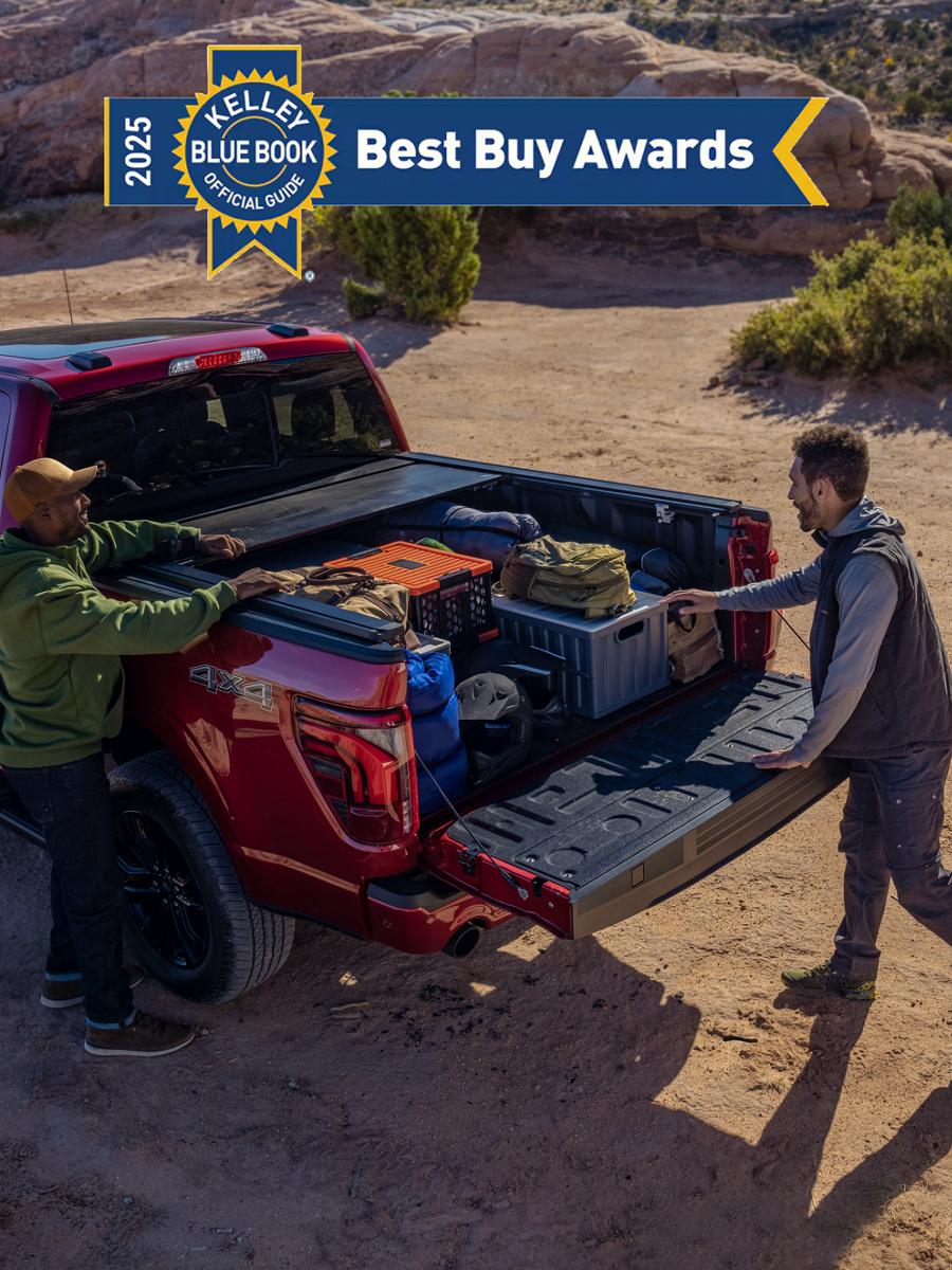 Two people loading items in the bed of a 2025 Ford F-150® Lariat®. 2025 Kelley Blue Book Best Buy Awards badge shown on image