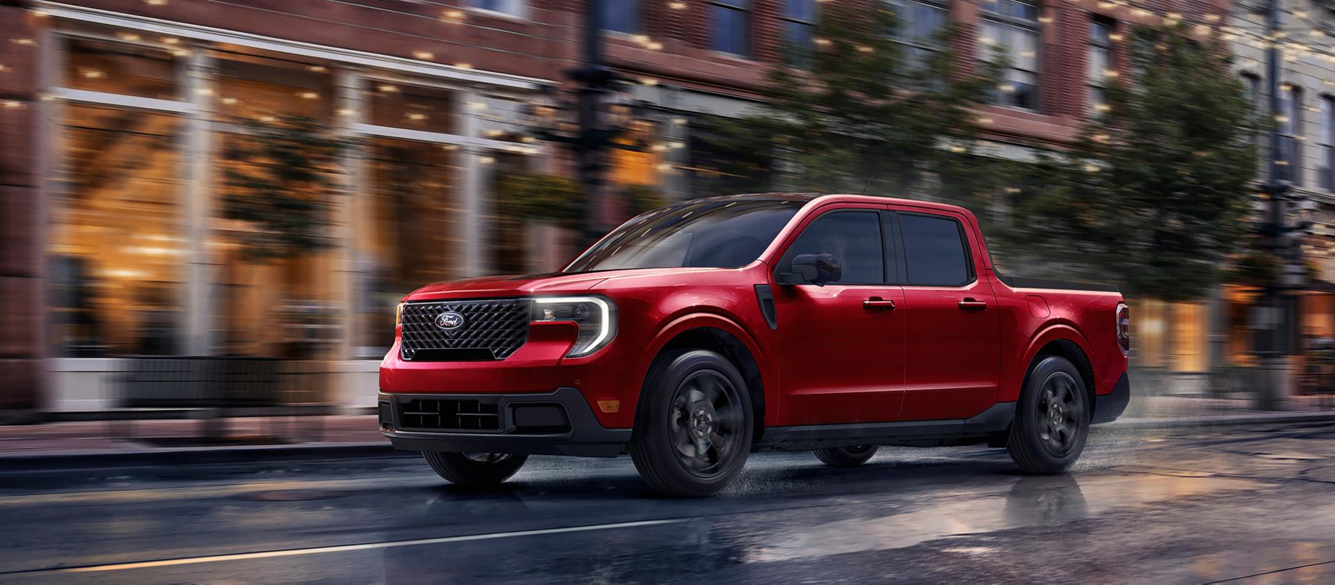 2026 Ford Maverick® pickup with Black Appearance Package being driven on a city street in the evening