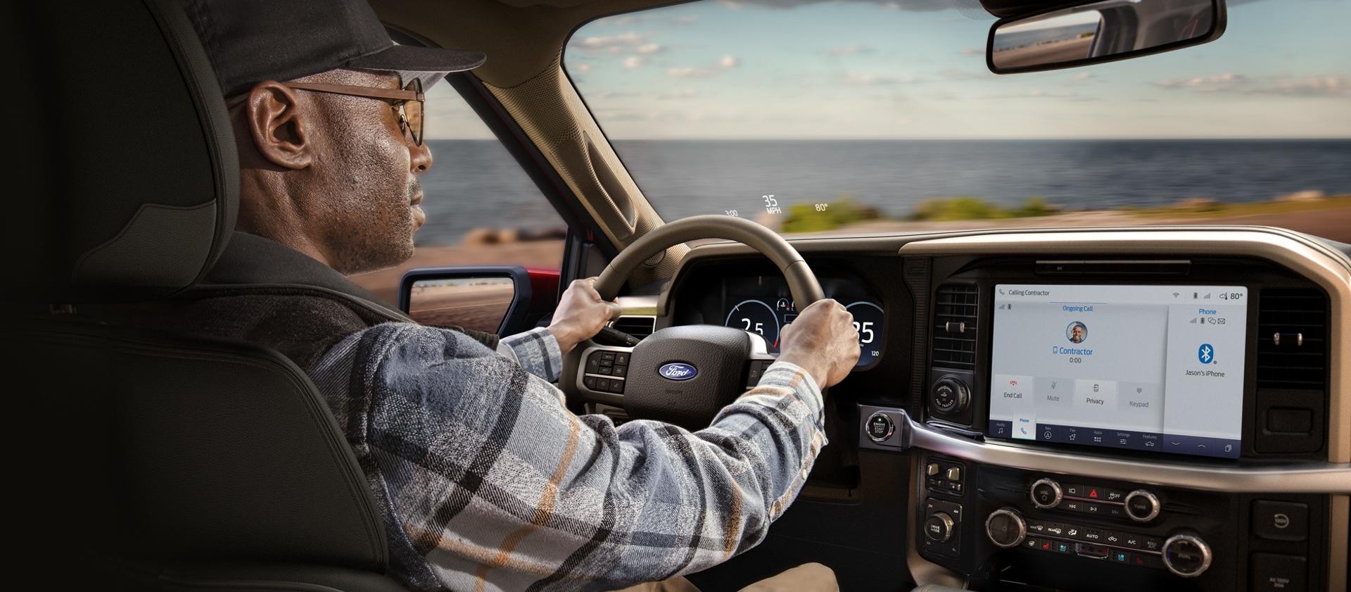 Man driving a 2026 Ford F-150® pickup showing the center display
