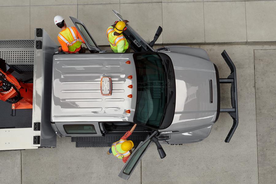 Aerial view of workers exiting 2026 Ford F-750® Crew Cab with aerial lift upfit in Iconic Silver
