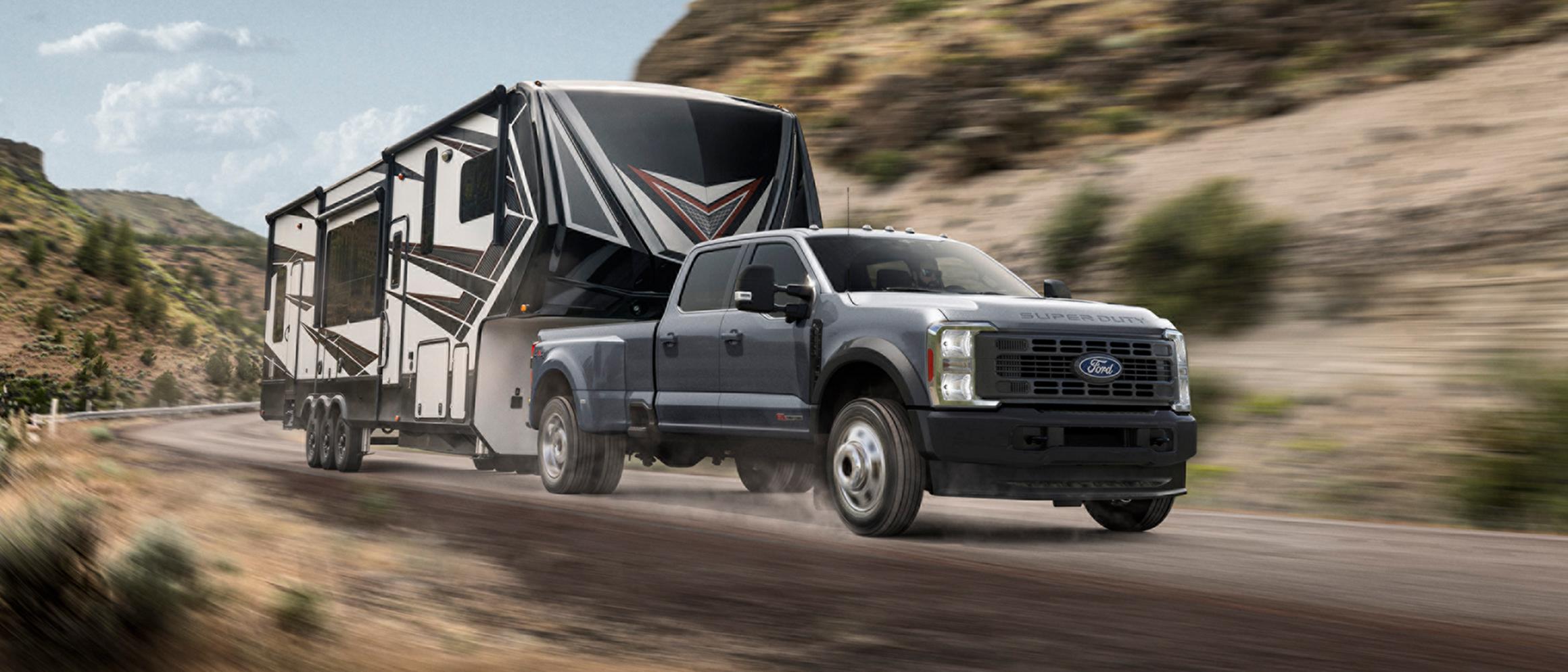 2027 Ford Super Duty® truck pulling a large trailer on a mountain road