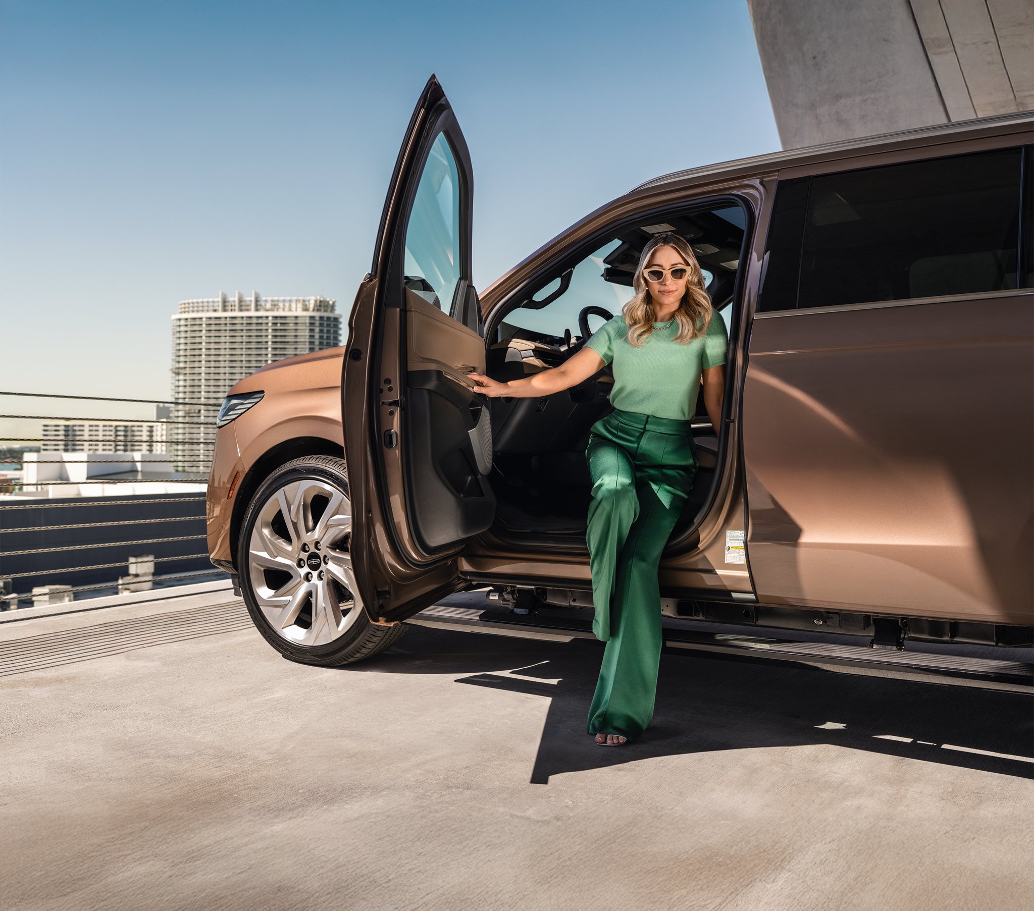 A woman getting out of her 2025 Lincoln Navigator.