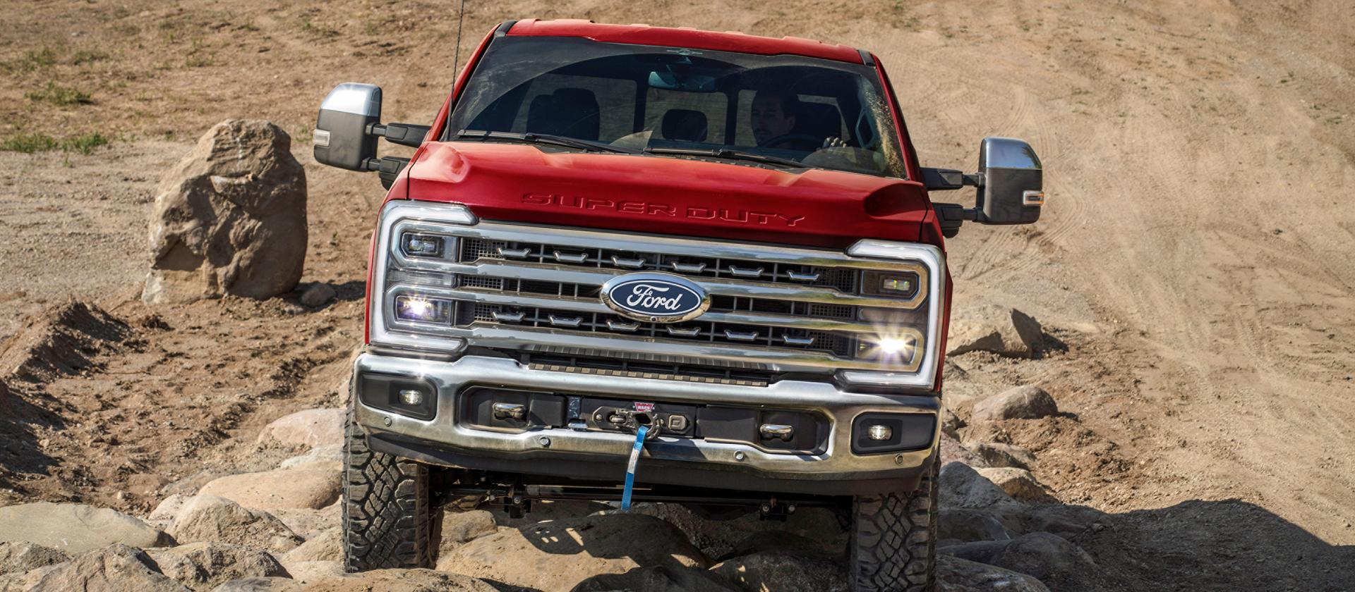 2027 Ford Super Duty® F-250 pickup with the Tremor Off-Road Package driving on rocky terrain