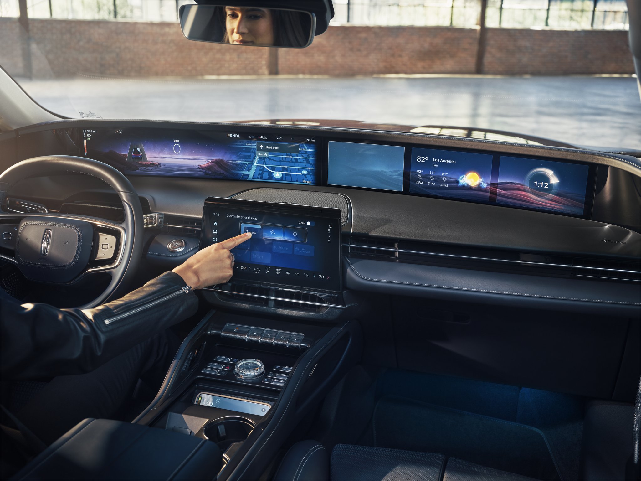 Turn-by-turn driving directions are shown on the panoramic display