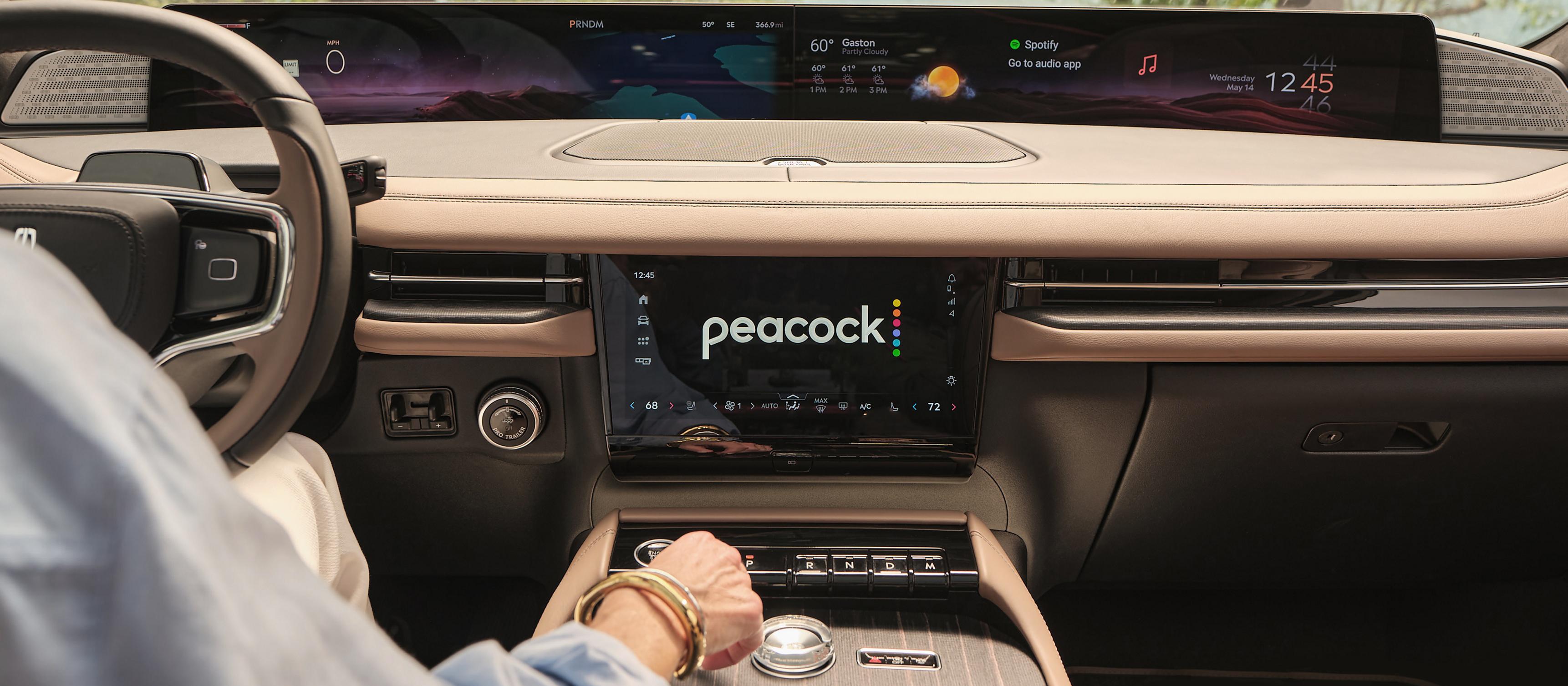 The interior of a 2026 Lincoln Black Label Navigator with a streaming app displayed on the center stack screen