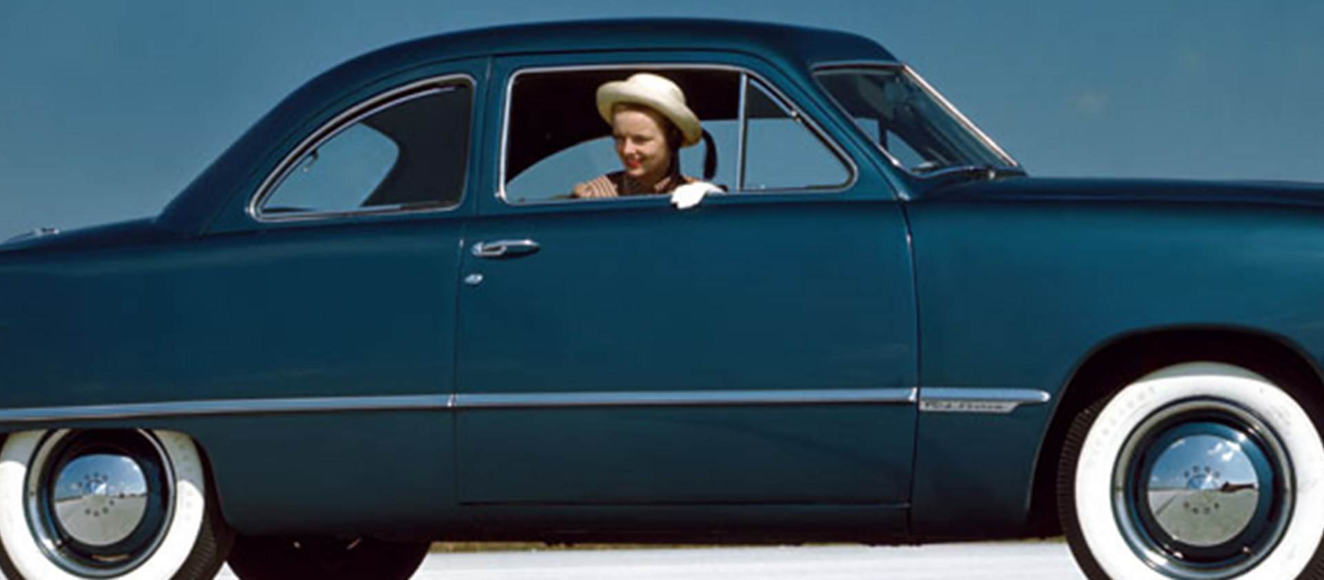 Woman in 1949 blue vehicle