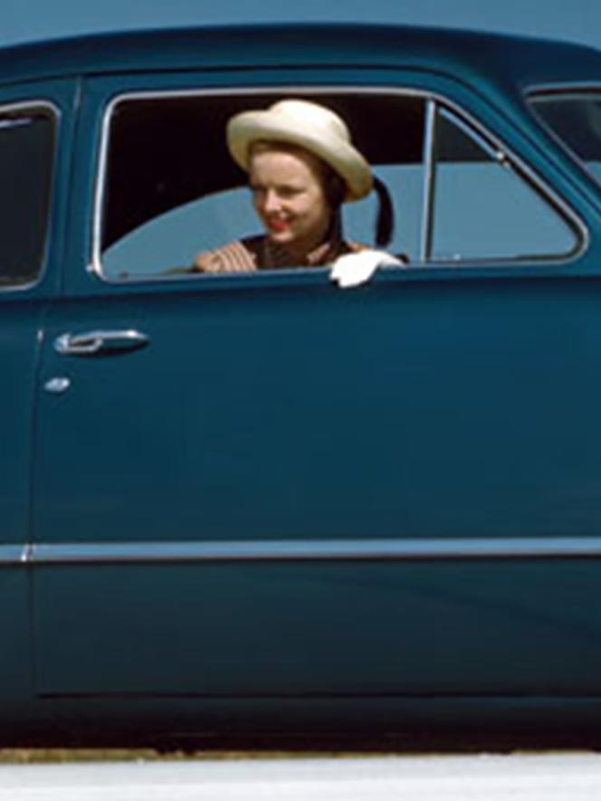 Woman in 1949 blue vehicle