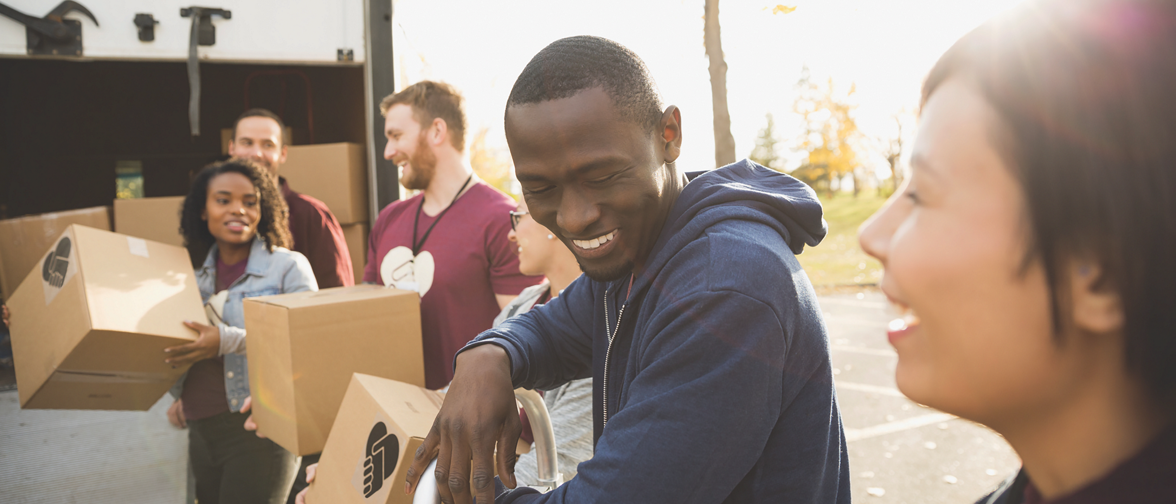 Ford employees do volunteer work carrying boxes for delivery
