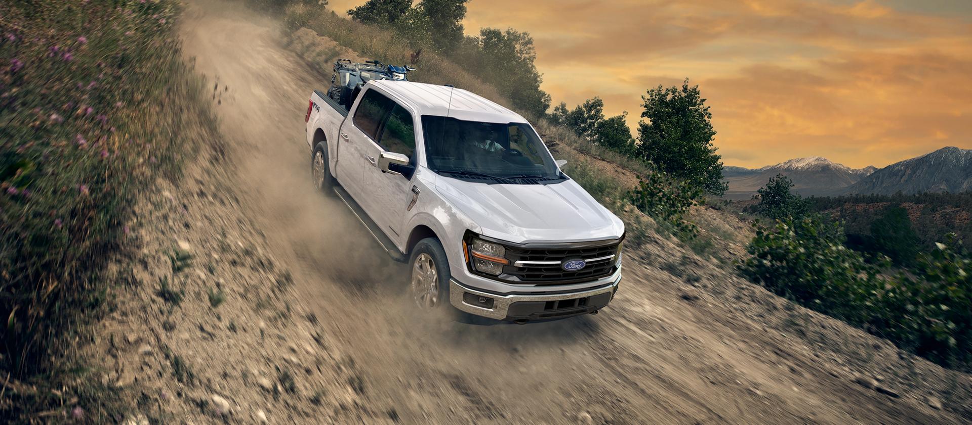 2026 Ford F-150® FX4® model being driven down a steep slope on a dirt road
