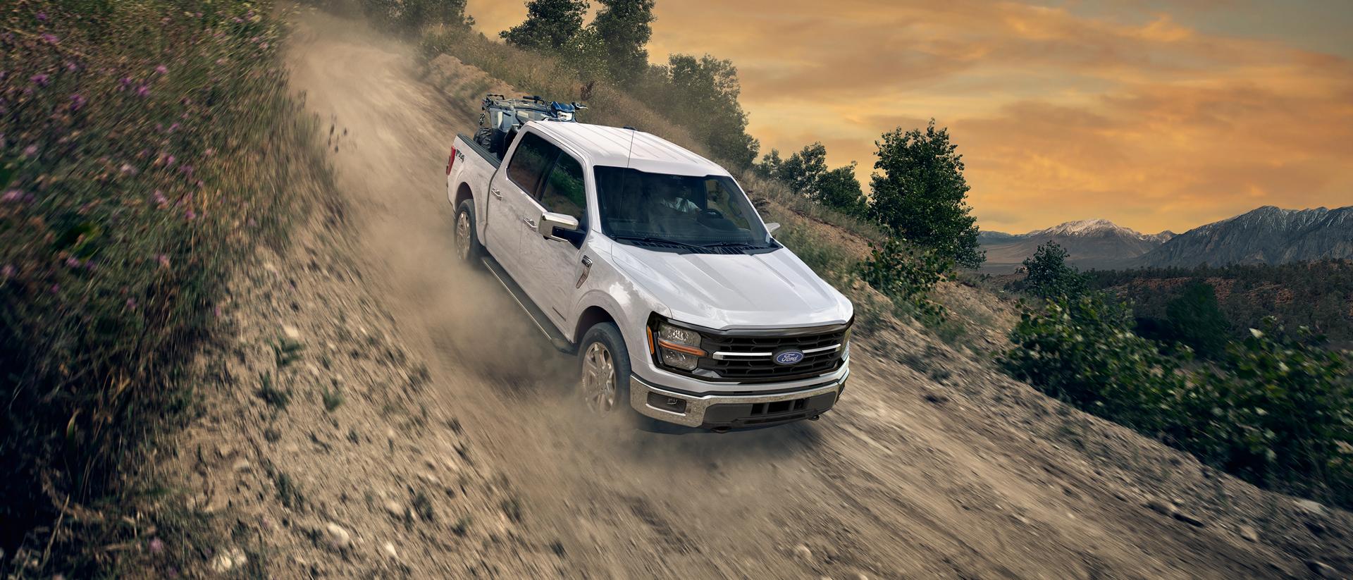 2026 Ford F-150® FX4® model being driven down a steep slope on a dirt road
