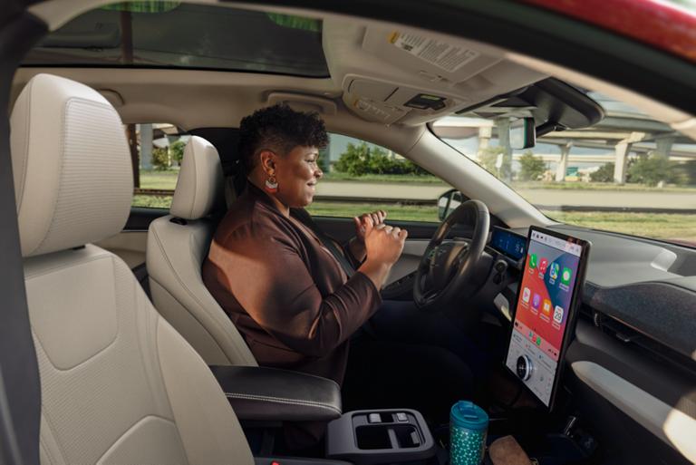 Woman using Ford Bluecruise hands-free highway driving in a 2025 Ford Mustang Mach-E®