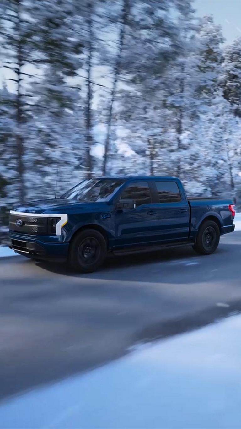 A 2025 Ford F-150 Lightning® driving in the winter