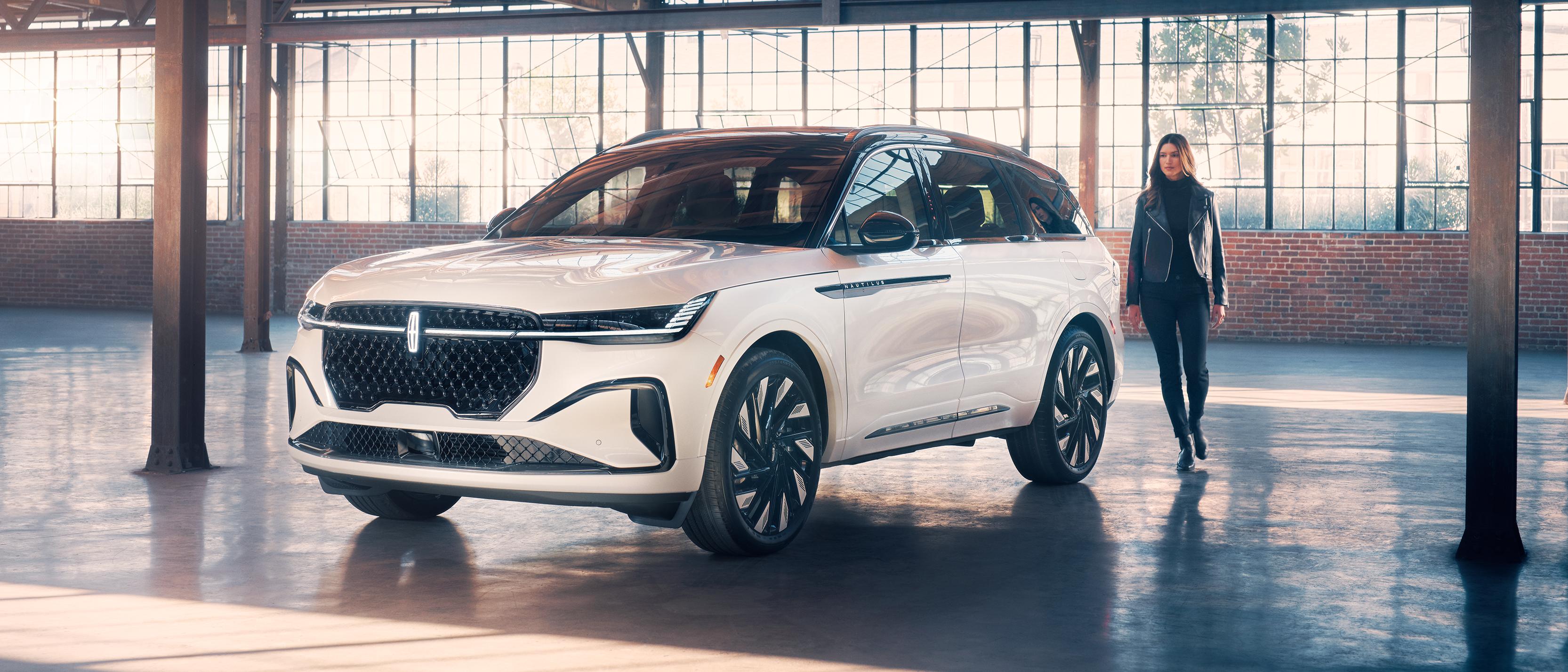 A woman approaches a 2026 Lincoln Nautilus® SUV in a parking garage
