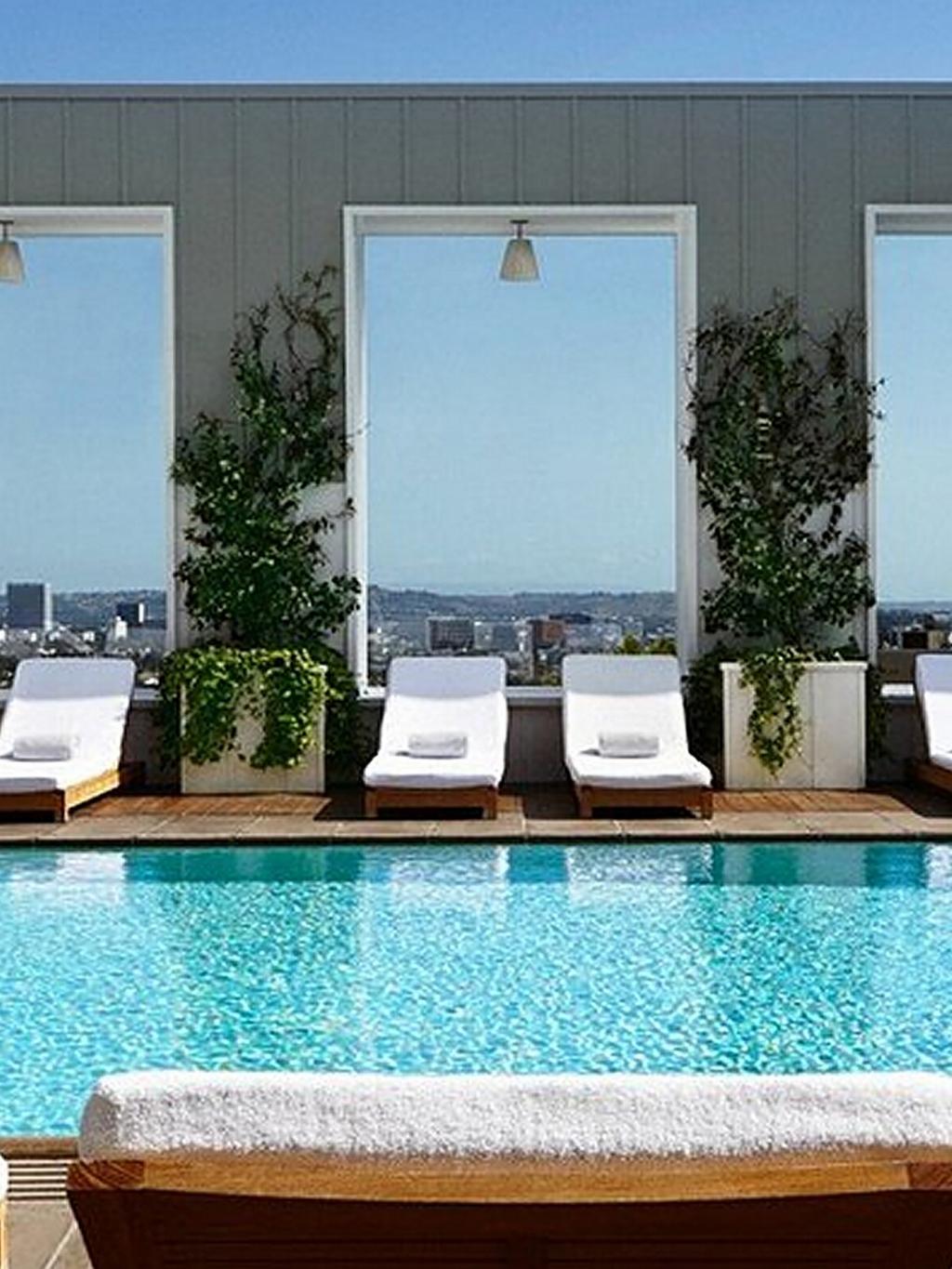 Chaise loungers poolside on a sunny day