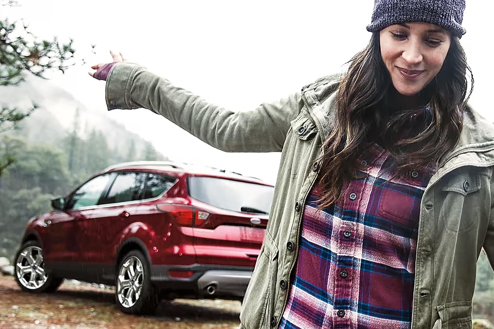 Driver beside a Ford SUV from the official Ford Blue Certified program page