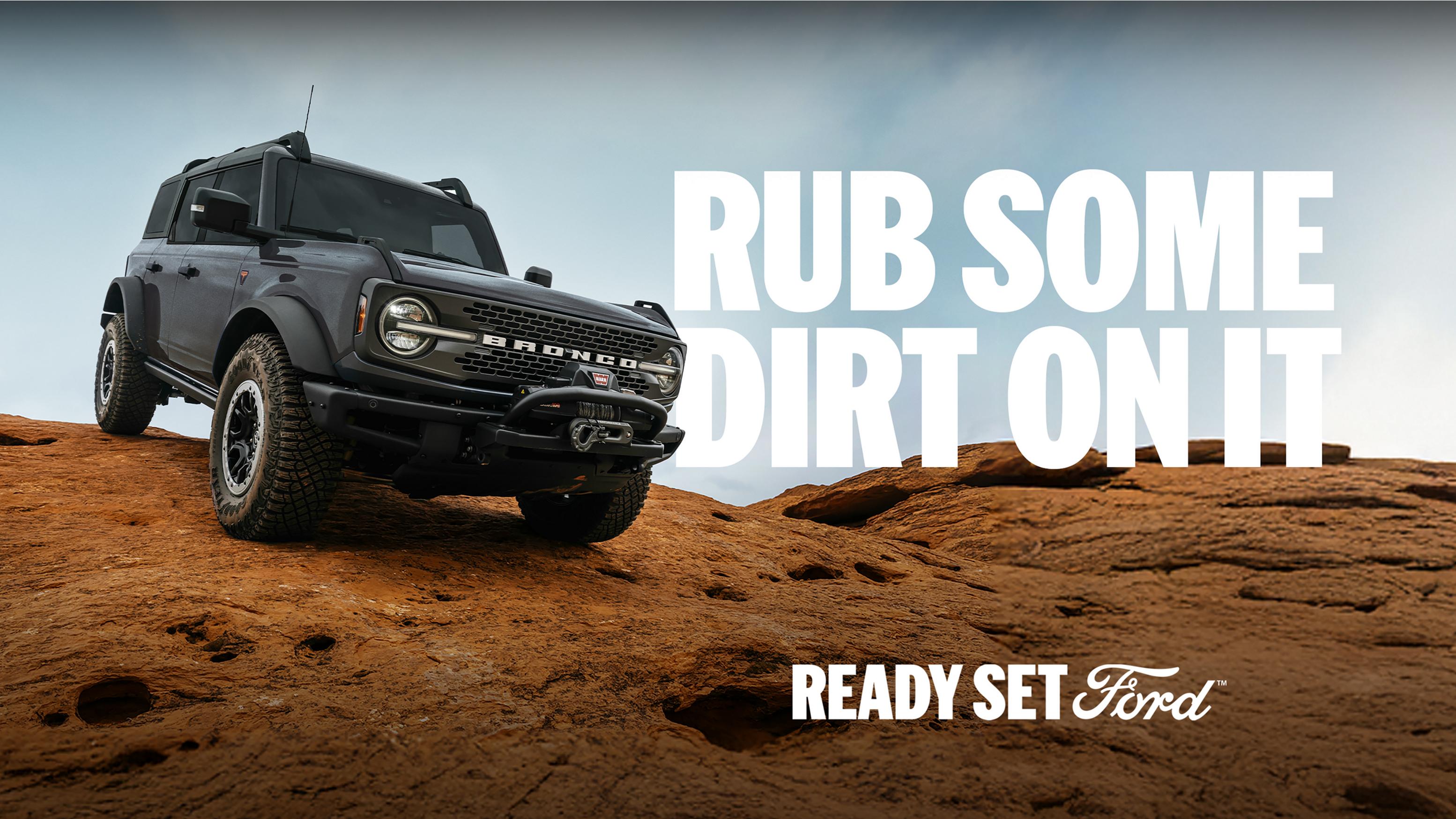 A 2026 Ford Bronco® SUV being driven down a dirt hillside