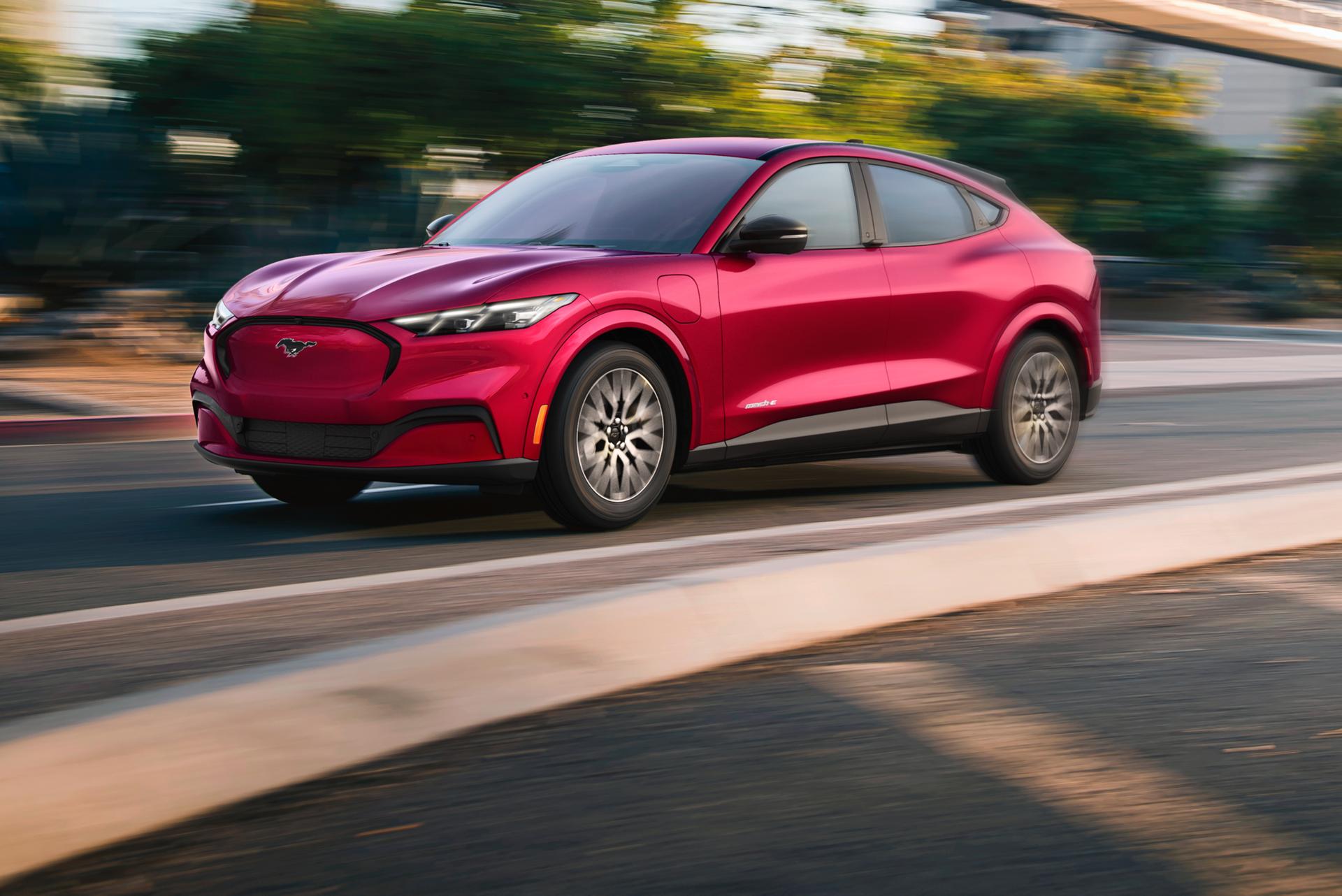 Ford Mustang Mach-E® SUV being driven down a tree-lined road