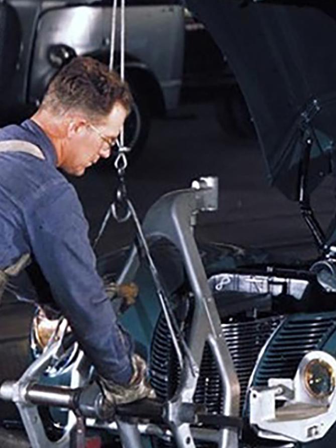 Two line workers and two teal vehicles