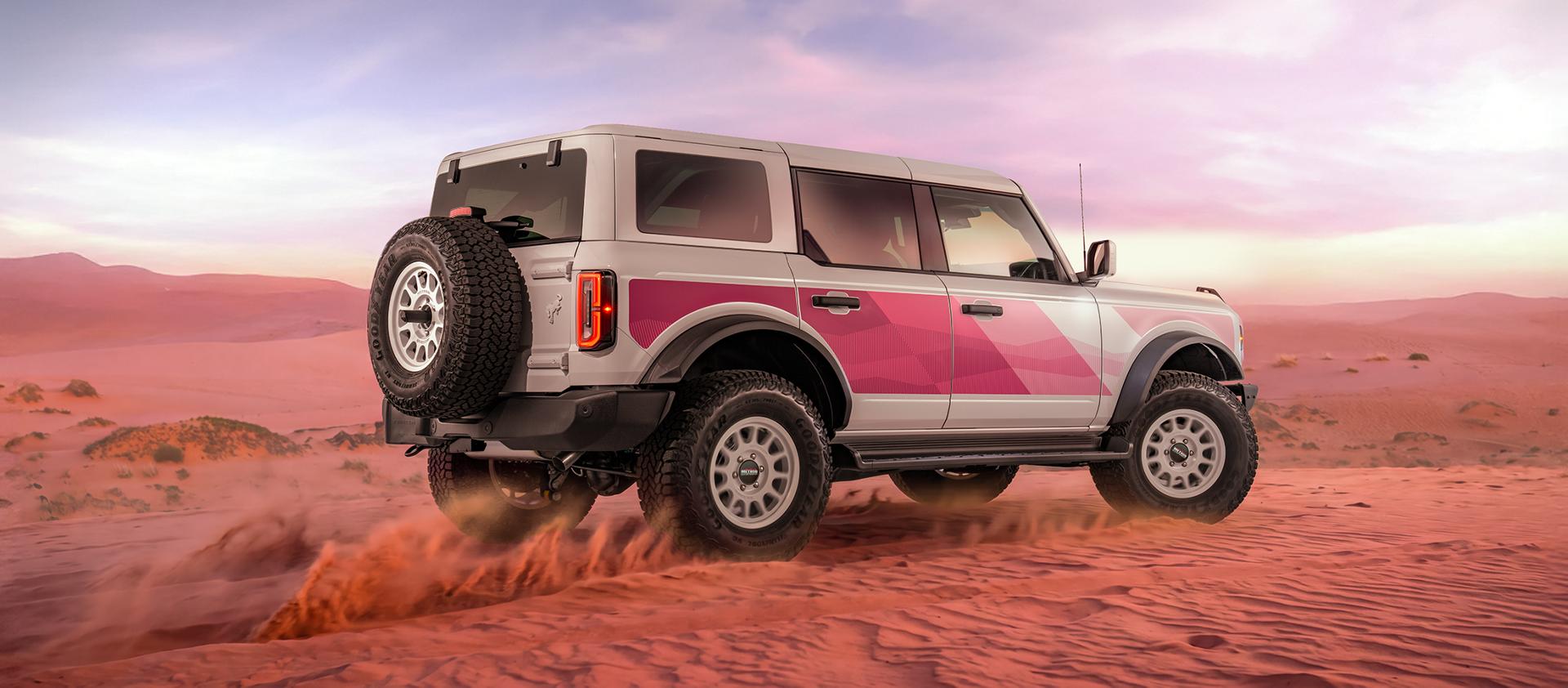 Rear three-quarter view of the Bronco in the desert at sunset