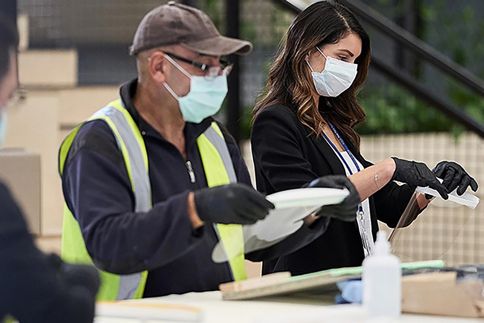 Workers inspect face shields