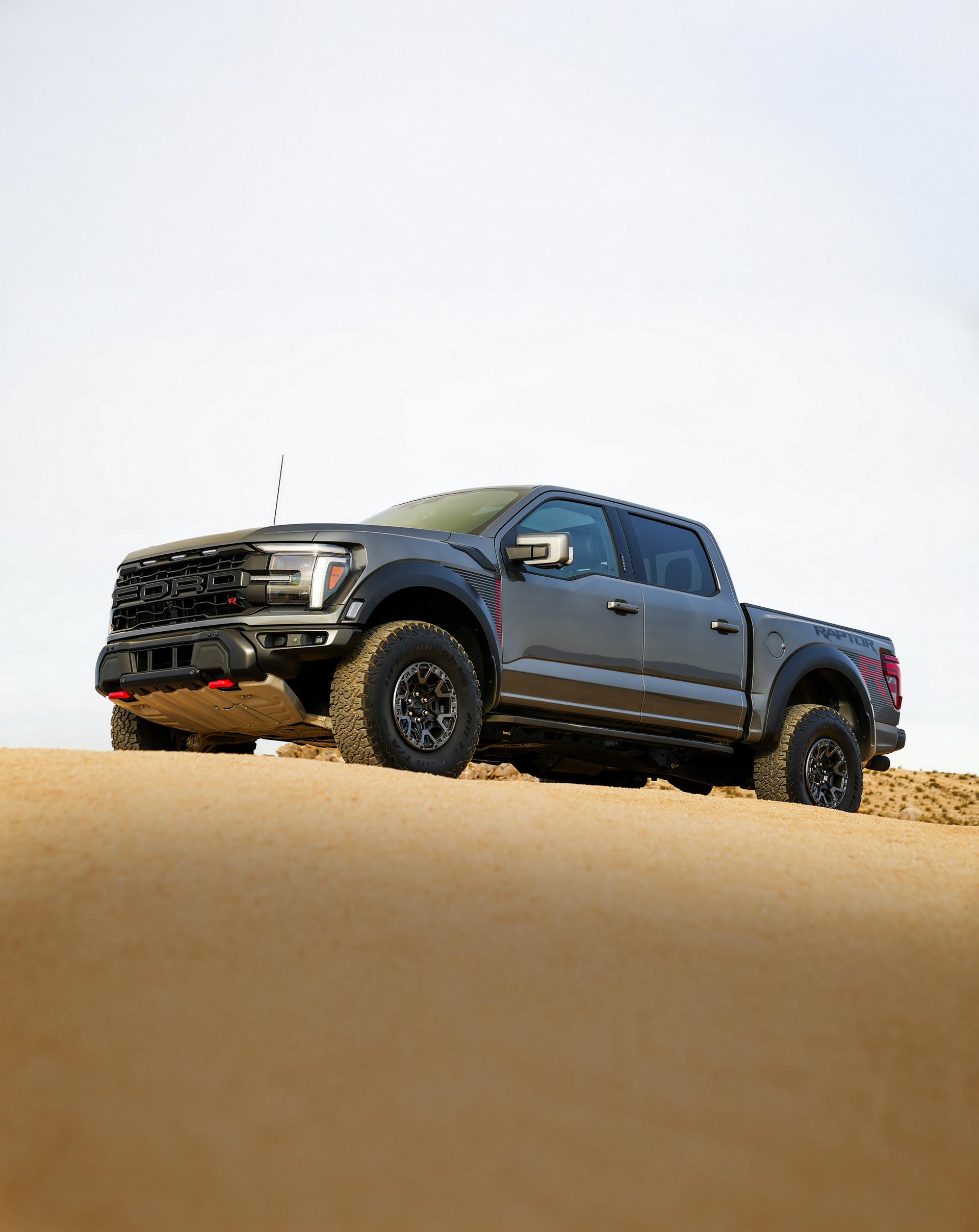 2025 Ford F-150® Raptor R™ truck in Carbonized Gray Metallic parked in the desert