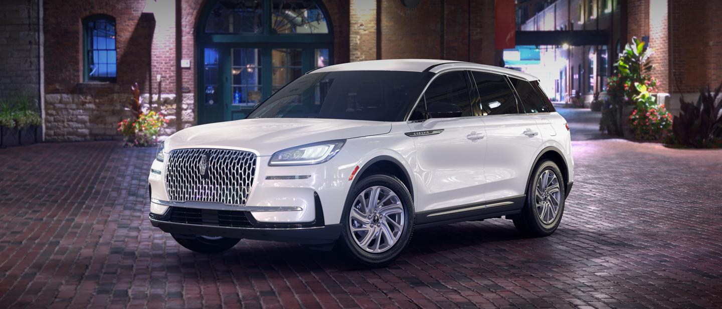 A 2026 Lincoln Corsair® premiere model is parked in a city at night