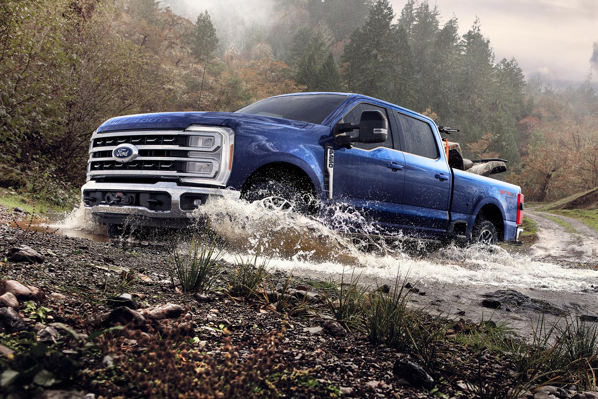 2026 Ford Super Duty® F-250® Lariat® pickup with the Tremor® Off-Road Package driving through a shallow creek
