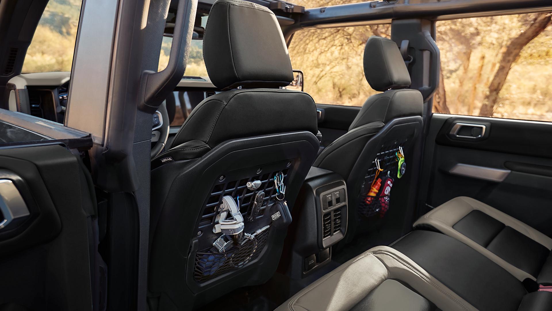 The rear seat area of a 2026 Ford Bronco® SUV, showing the MOLLE panels in the front seat backs