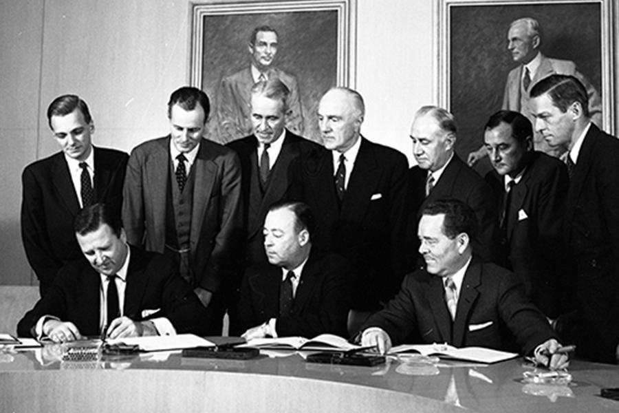Black and white image of stock shares signing event