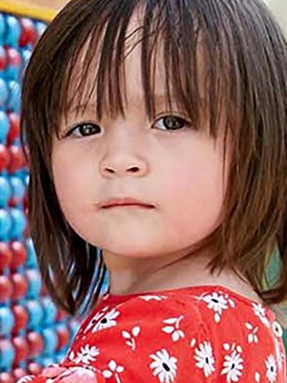 Little girl with blue and red wall