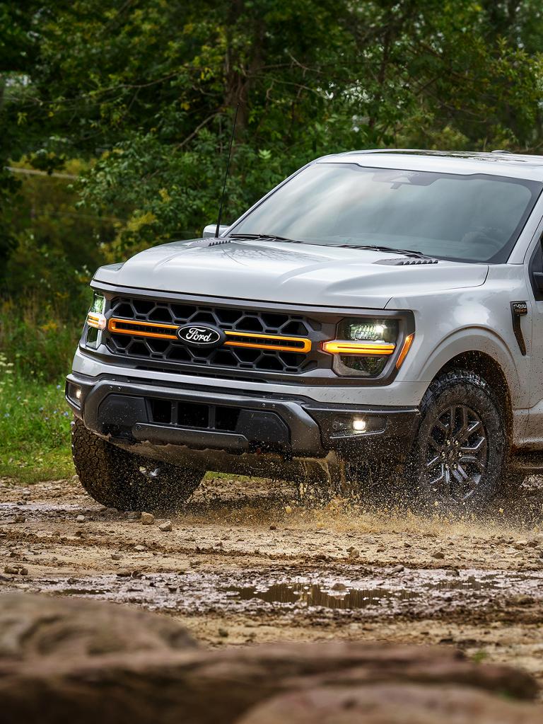 2026 Ford F-150® Tremor® pickup being driven through a muddy puddle