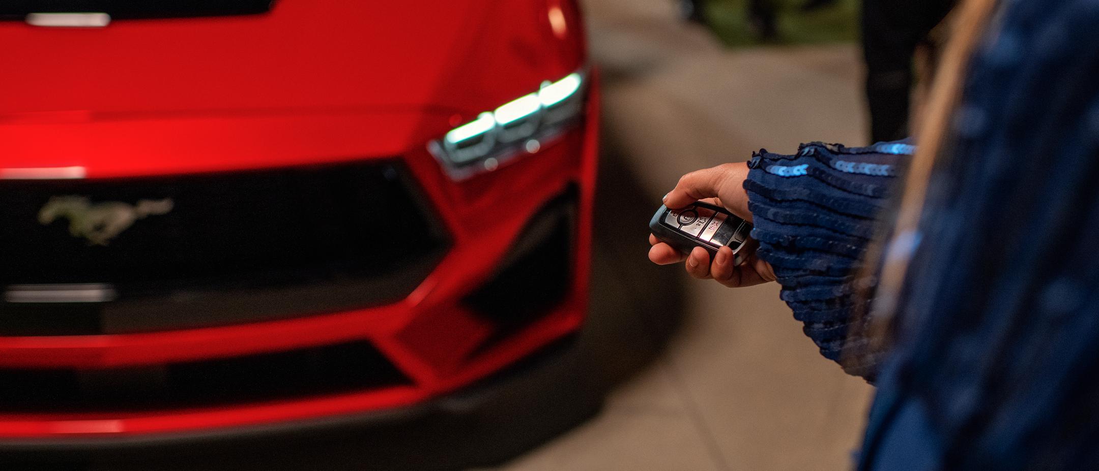 Person using the remote rev feature on a 2025 Ford Mustang® coupe with available automatic transmission