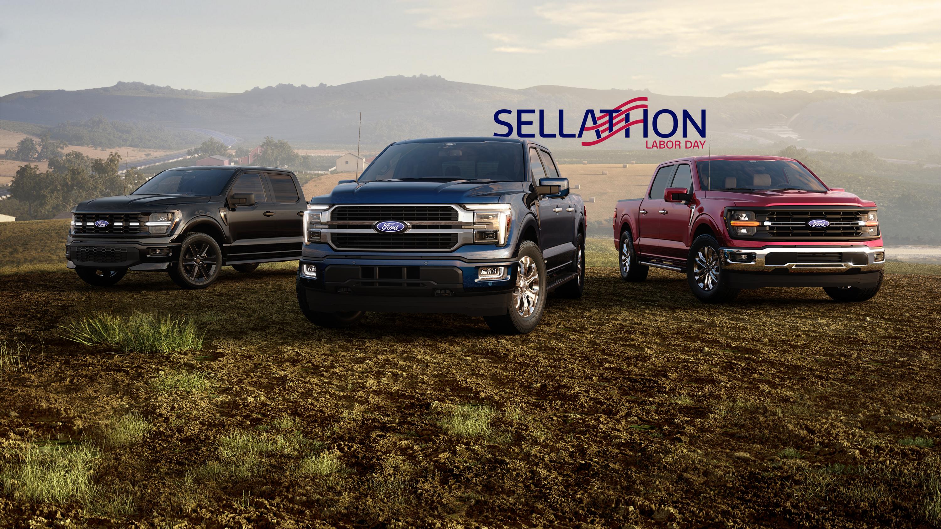 Three 2026 Ford F-150 Trucks parked in rural field area.