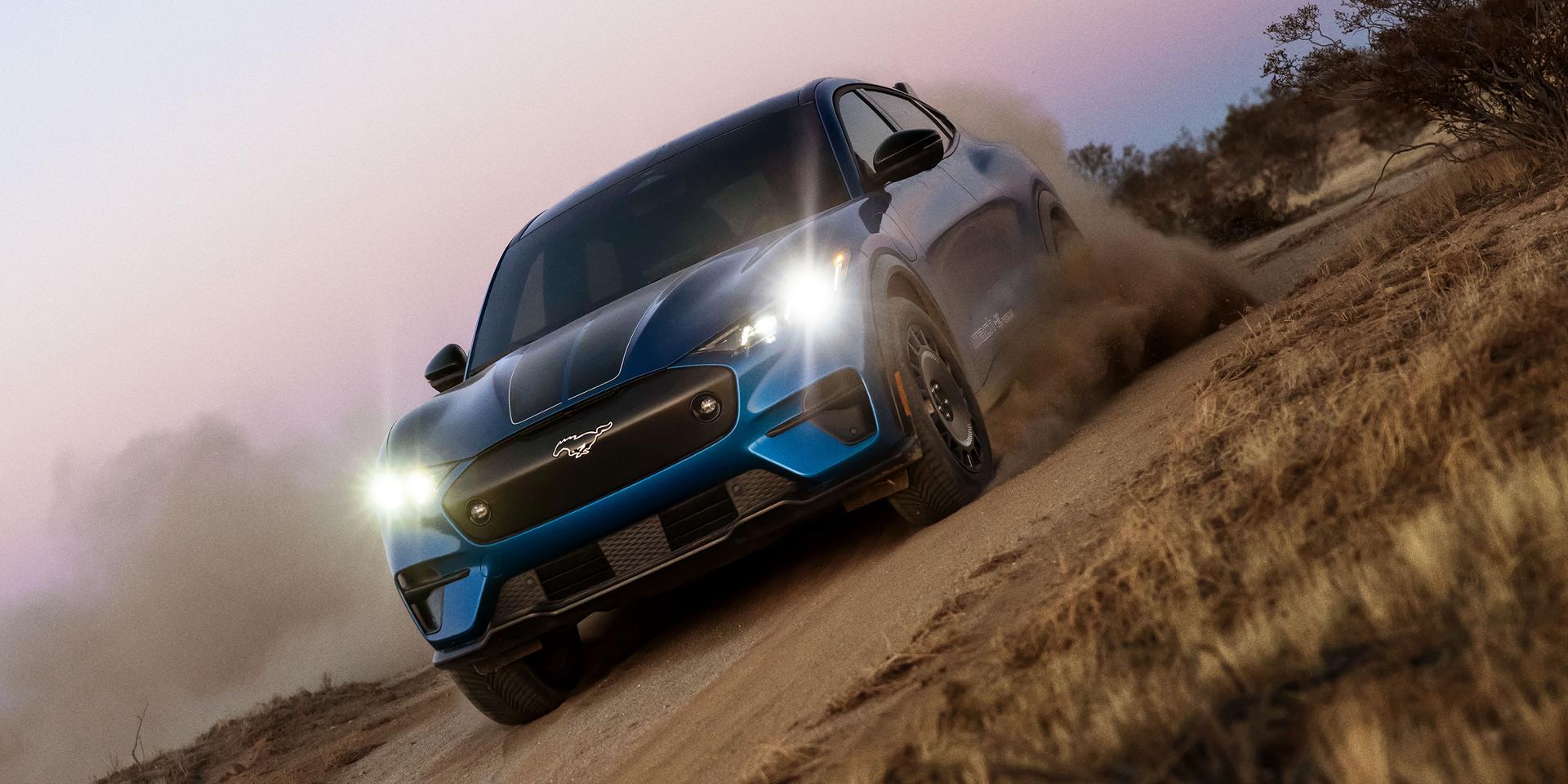 A 2025 Ford Mustang Mach-E® Rally racing on a dirt road