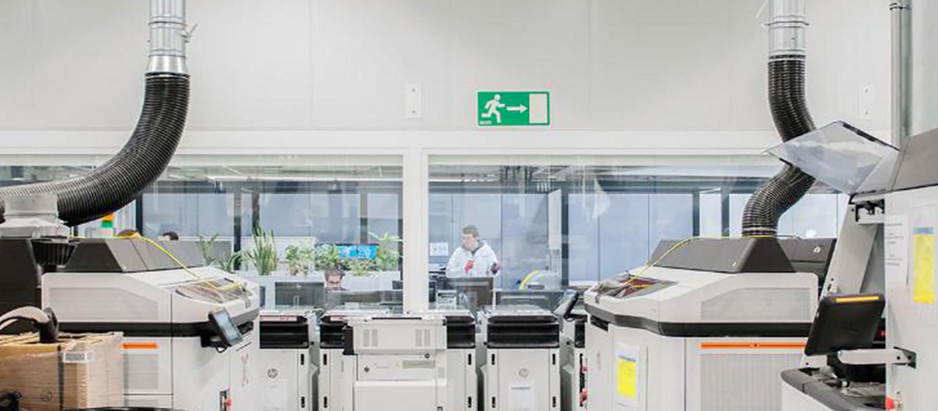 3D printers lined up in room