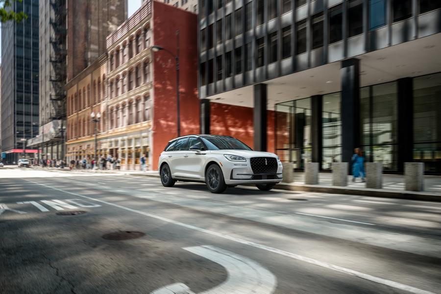 A 2025 Lincoln Corsair with the available Jet Appearance Package is being driven in a city setting