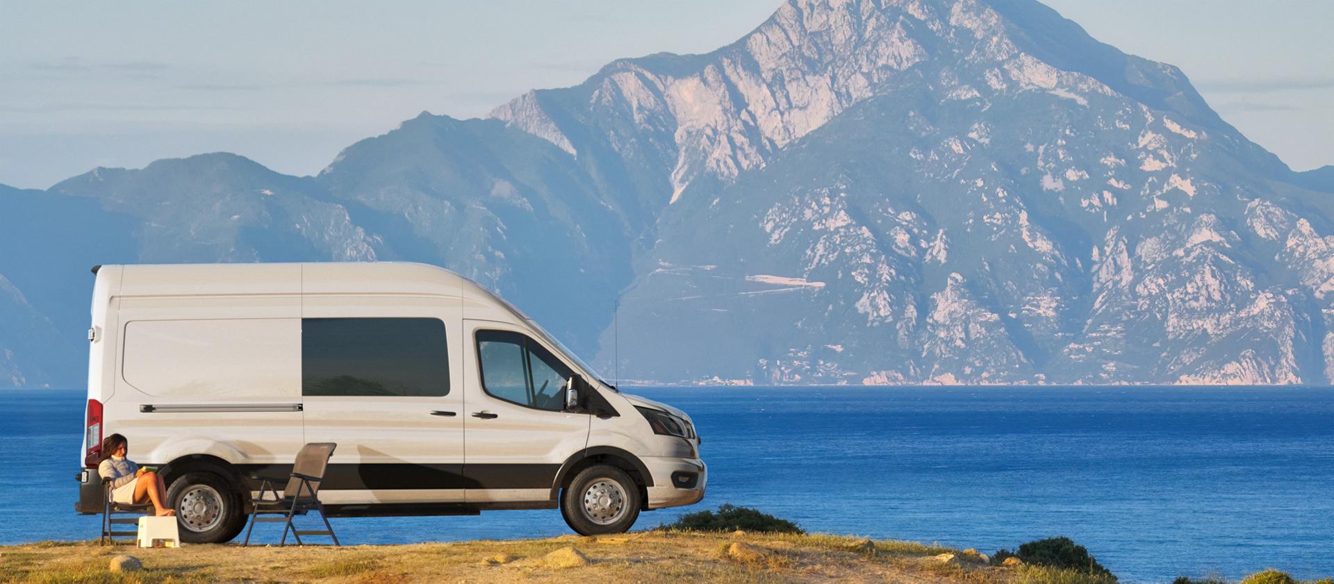 A 2026 Ford Transit® van parked overlooking a mountain landscape
