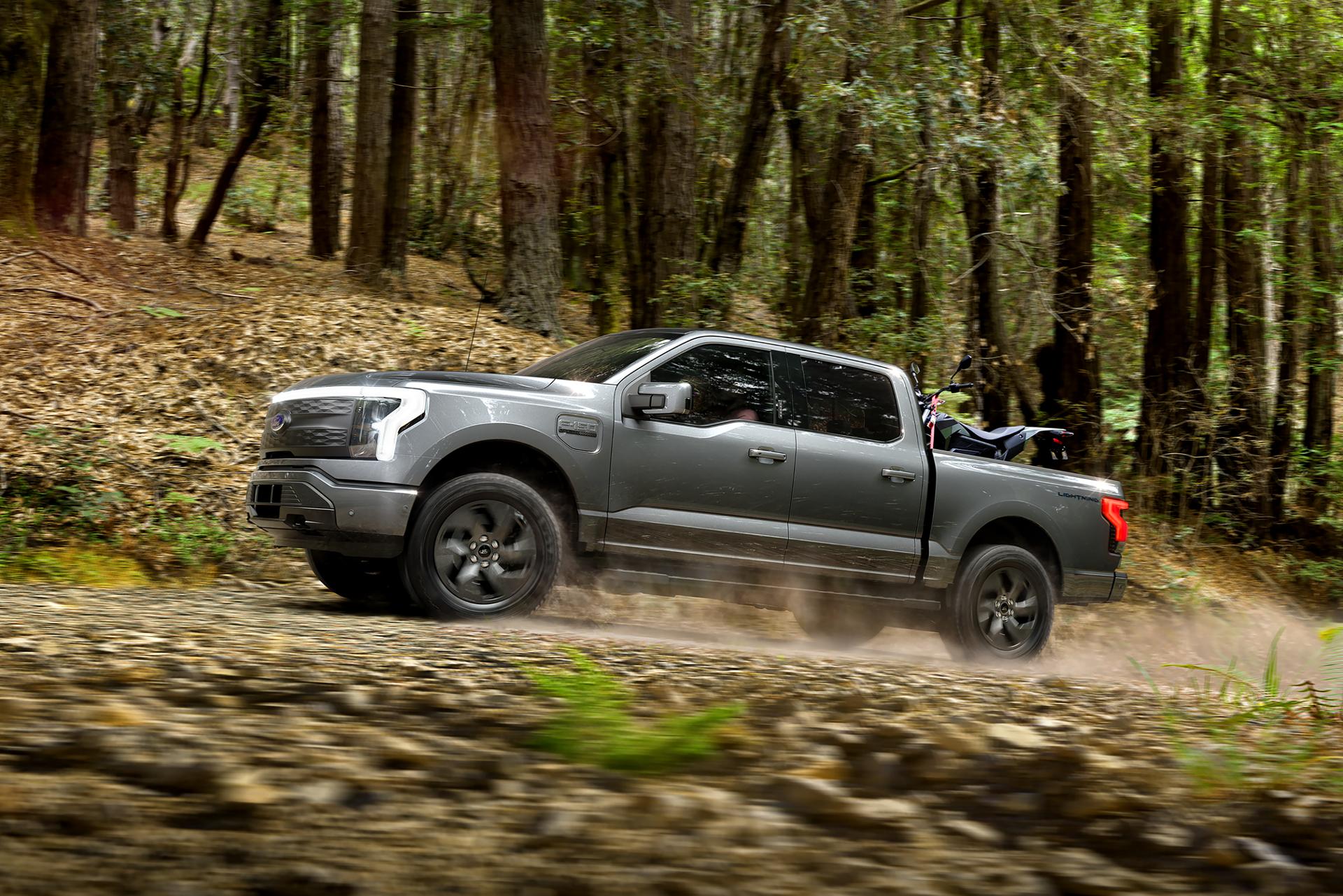 Ford F-150® Lightning® being driven on a rough trail through the woods