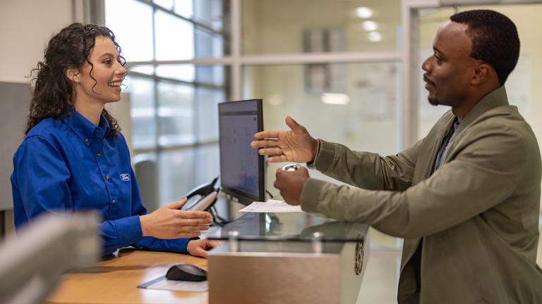 A Ford customer chats with a Ford Service rep