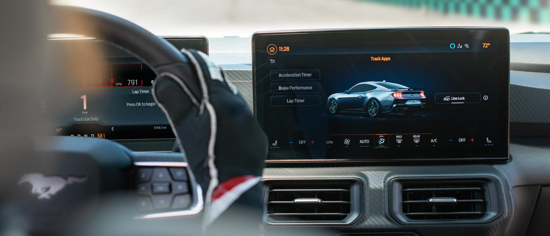 Interior view of a person driving a 2025 Ford Mustang® model on a closed course