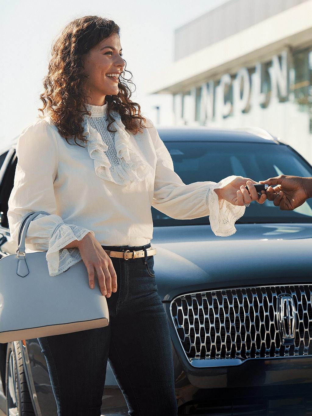 A Lincoln customer receives their keys back from a service advisor