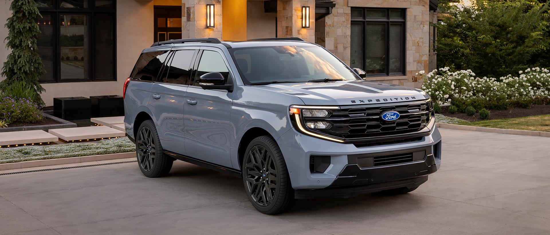 2027 Ford Expedition® Platinum® SUV with available Stealth Performance Package parked in a driveway