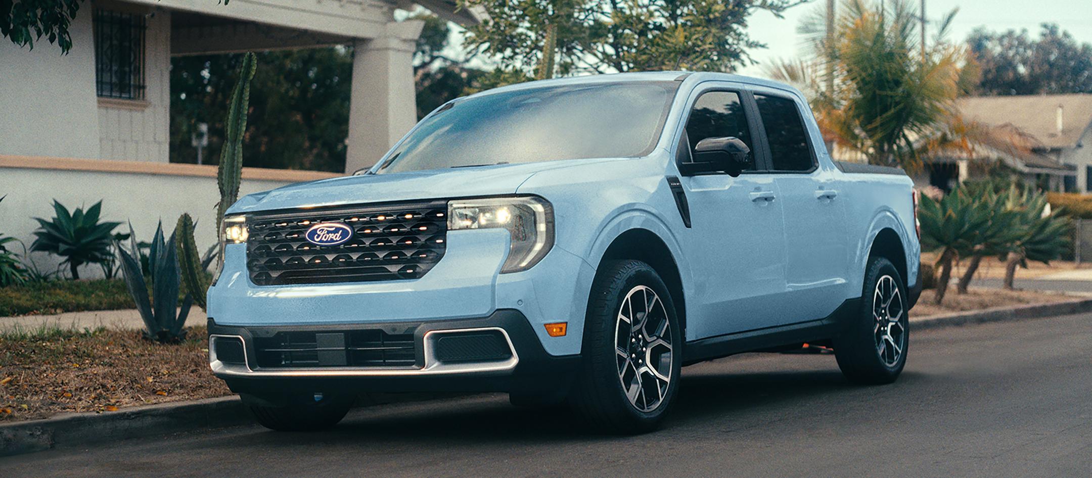 2026 Ford Maverick® pickup in Robins Egg Blue parked on the street in front of a home
