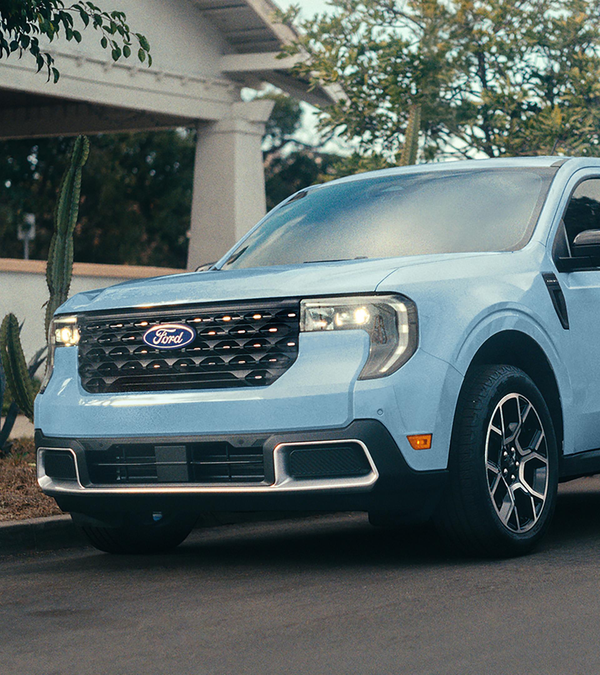 2026 Ford Maverick® pickup in Robins Egg Blue parked on the street in front of a home