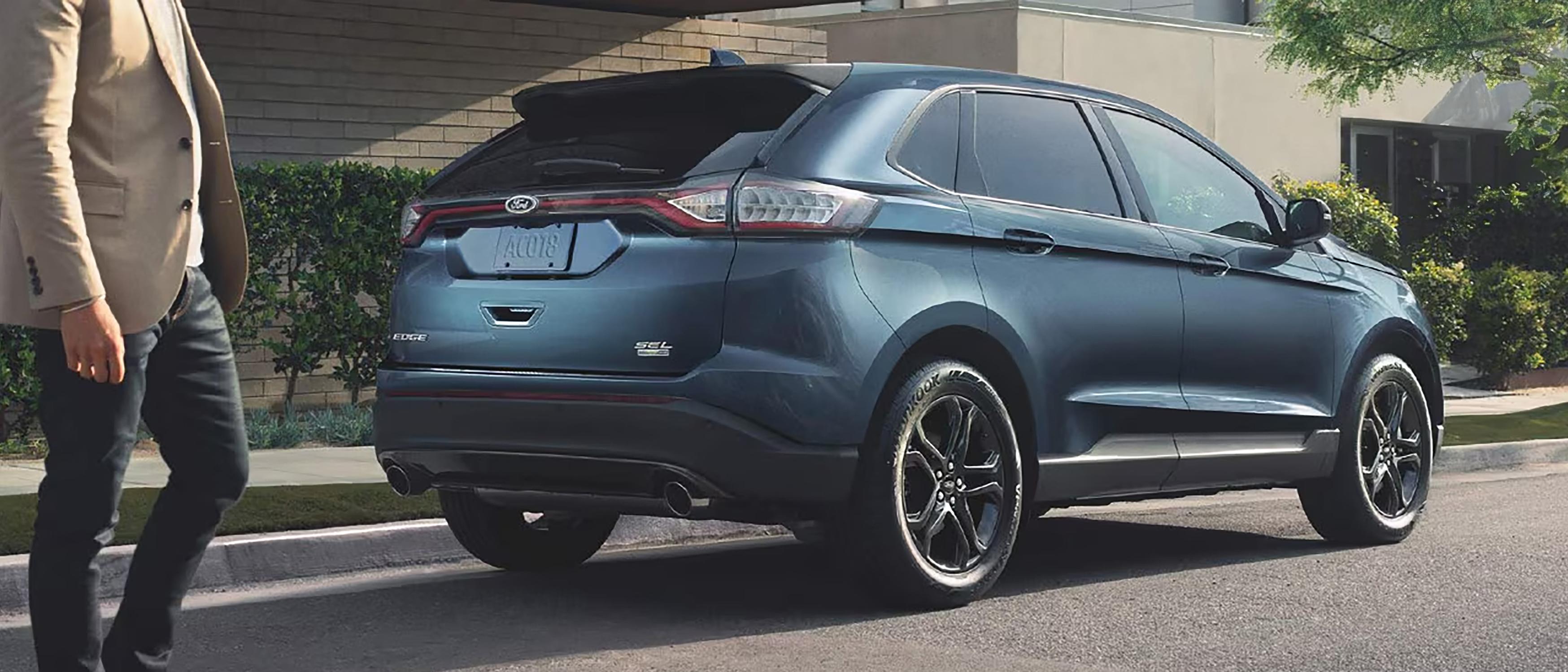A Ford Edge® SUV parked streetside catches the attention of an onlooker