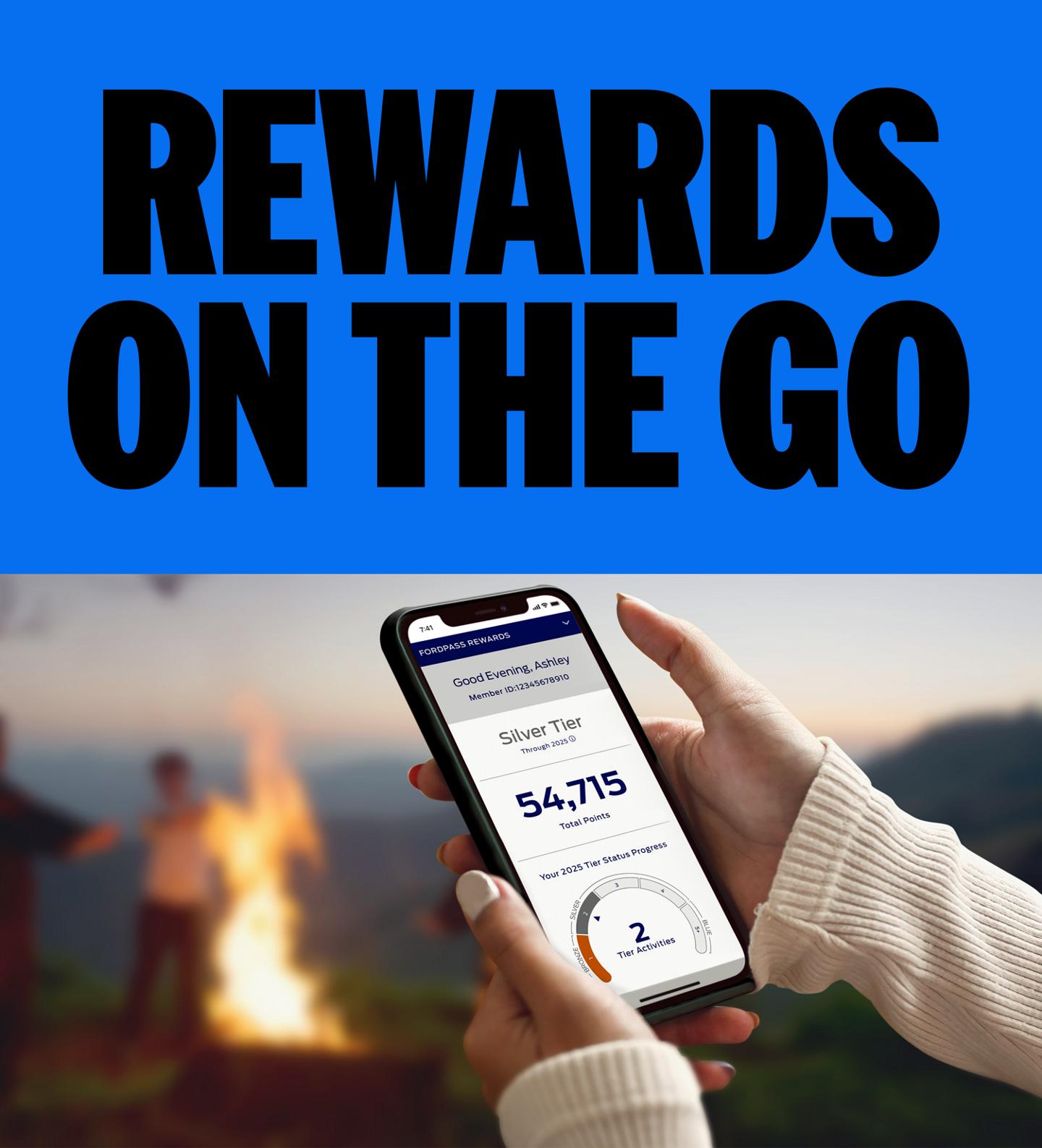 A person holding their smartphone while looking at the FordPass® Rewards app