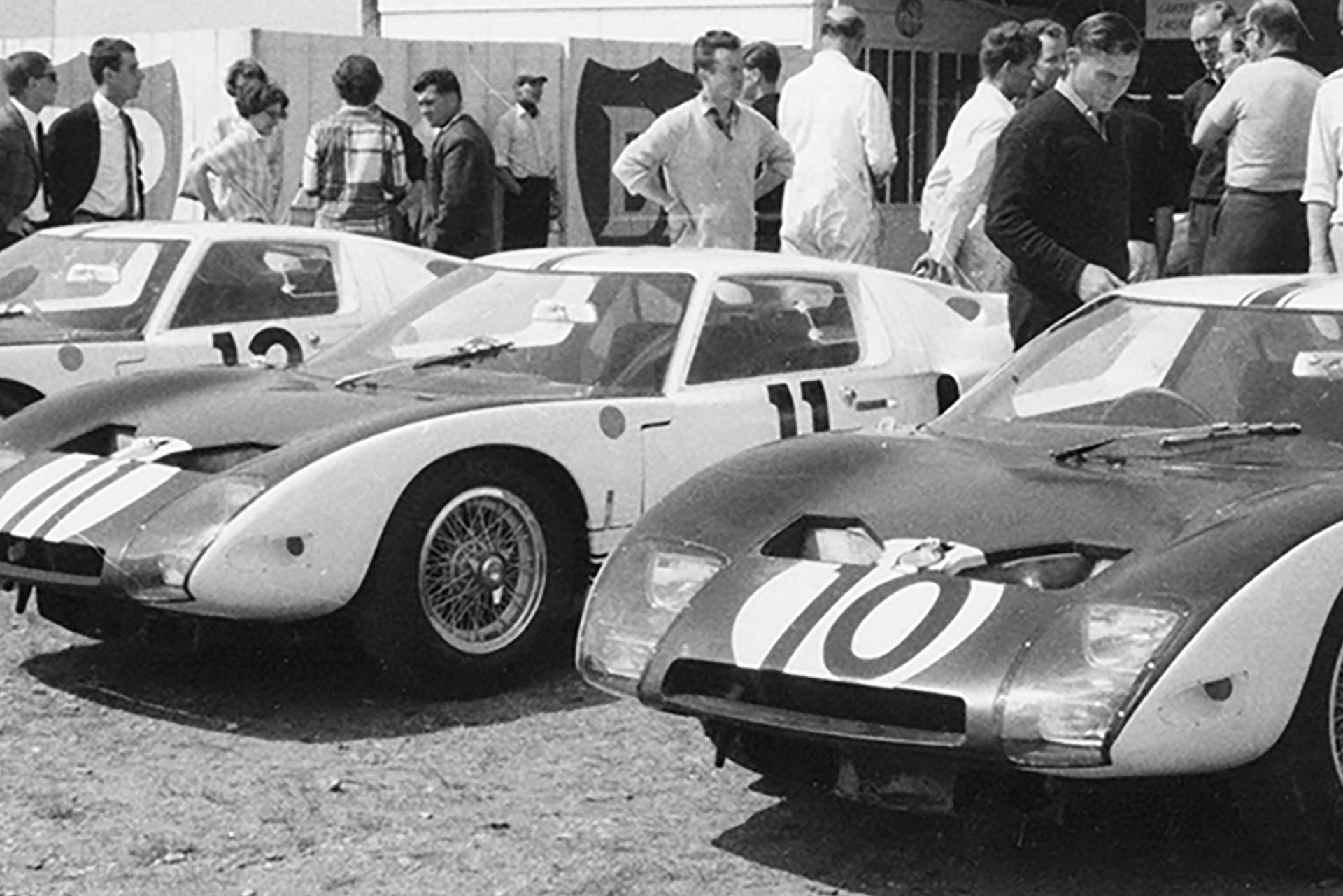 The Ford team in discussion at the track. The three Ford GT40s in the foreground