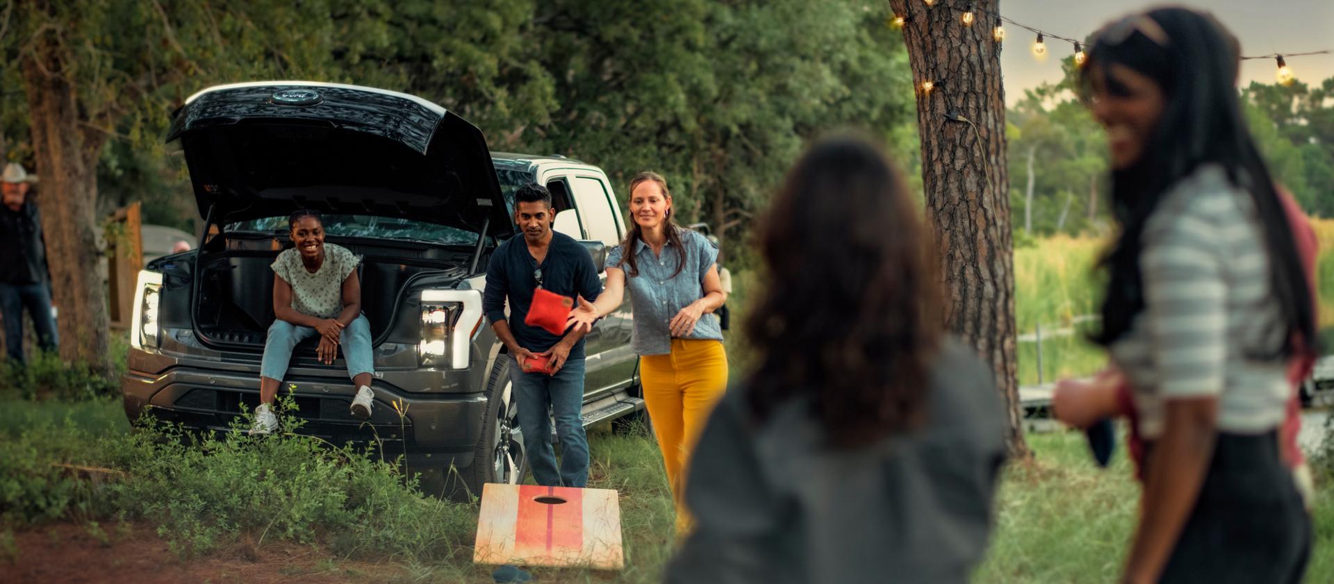 Family using their 2025 Ford F-150 Lightning truck while camping